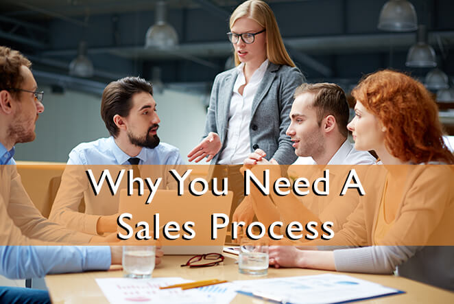 A group of five young salespeople disscussing